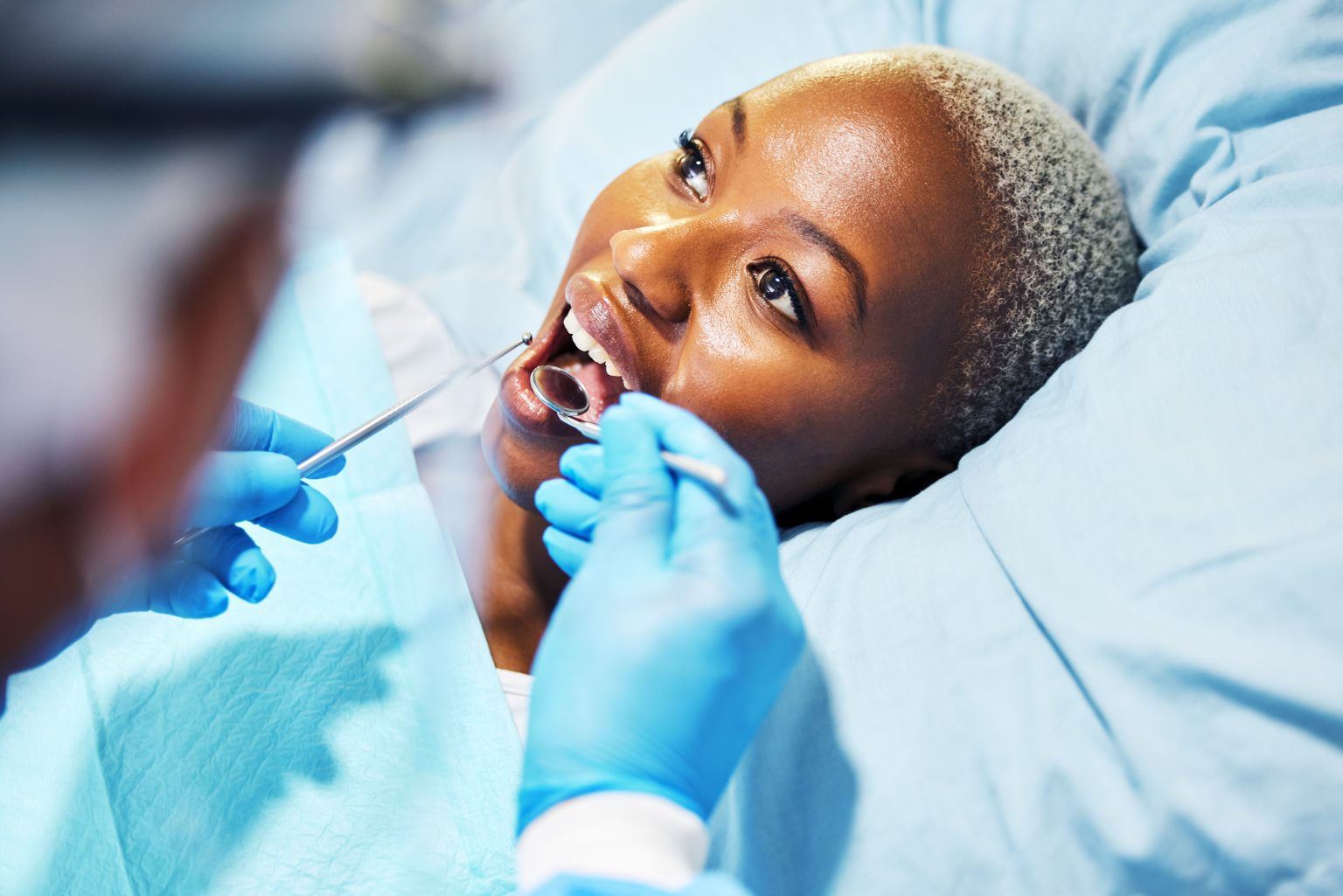 Dentist, inspection and woman with tools in mouth at clinic for cavity, teeth whitening and helping.